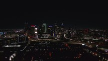 Tracking Aerial of Dallas City Skyline at Night	