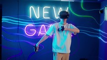 A guy moves his arms around while playing a virtual reality game. 