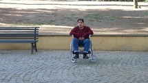 a man in a wheelchair looking up 