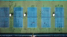 Tennis players play on the tennis courts aerial