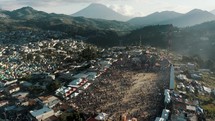 Aerial orbit shot of Crowd Of People At The Venue Of Giant Kite Festival In Sumpango, Guatemala. Day of the Dead (Dia De Los Muertos).