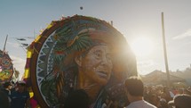 Bright Sun Shining Behind The Giant Kite Painted With Old Man's Face During The Sumpango's Festival In Guatemala. - POV