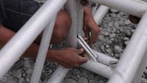 Asians Working With Metal Assembling Scaffolding