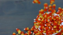 candy corn dropping into a bowl 