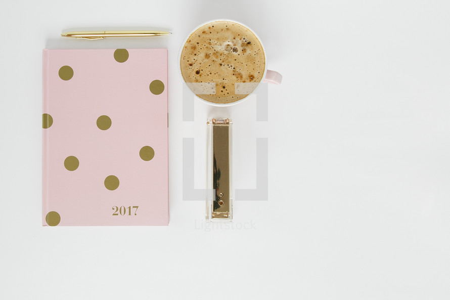 pink and gold polka dot 2017 planner, pen, stapler, and latte 