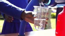 pouring filtered water into a cup 