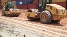 Heavy duty machines working on asphalt in a port 
