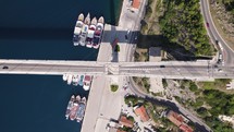 Aerial top down of Dr Franjo Tudman Bridge as cars drive below, Dubrovnik Croatia