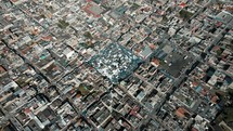 Plaza de Ponchos In The Heart Of Otavalo City In Ecuador. - aerial	