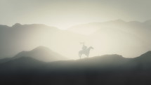 Roman Soldier Holding a Draco on a Horse in the Mountains