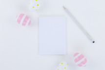 Easter eggs, pencil, and notepad 