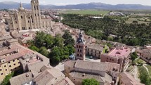 Segovia's Aerial: Iglesia de San Esteban and Segovia Cathedral amidst cityscape	