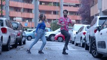 Couple dancing in the street.