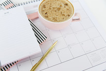 latte on a planner and notepad 