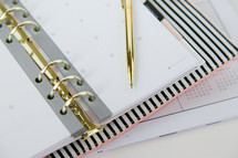 a pen on a planner 