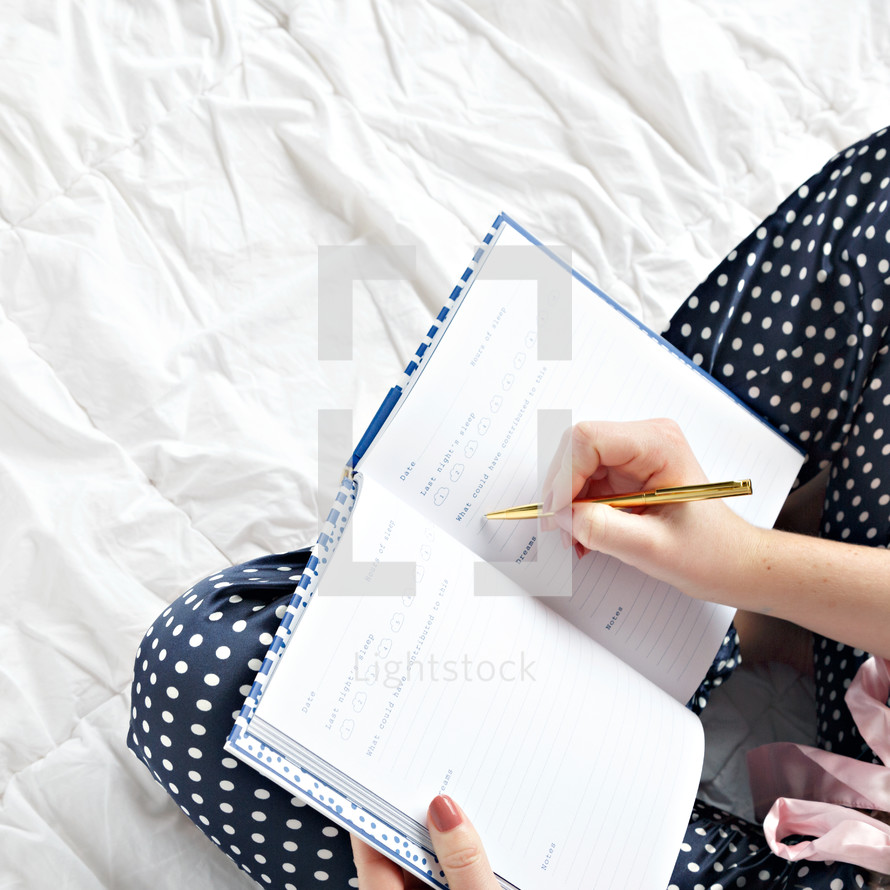 a woman writing in a journal 