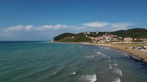Corfu island, Greece - 2023.07.01 - 09: Drone video of sunny day at Agios Stefanos Beach, Corfu Island, with stunning blue water