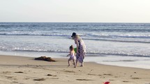 mother and toddler on a beach 