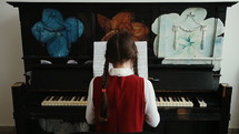 Playing piano music. Girl practicing on classical instrument. Medium shot.
