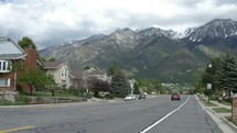 cars driving in a mountain neighborhood 