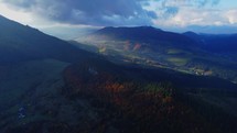 Bird's eye view of autumn rural landscape,forest hilly landscape , sunlight illuminating the hills