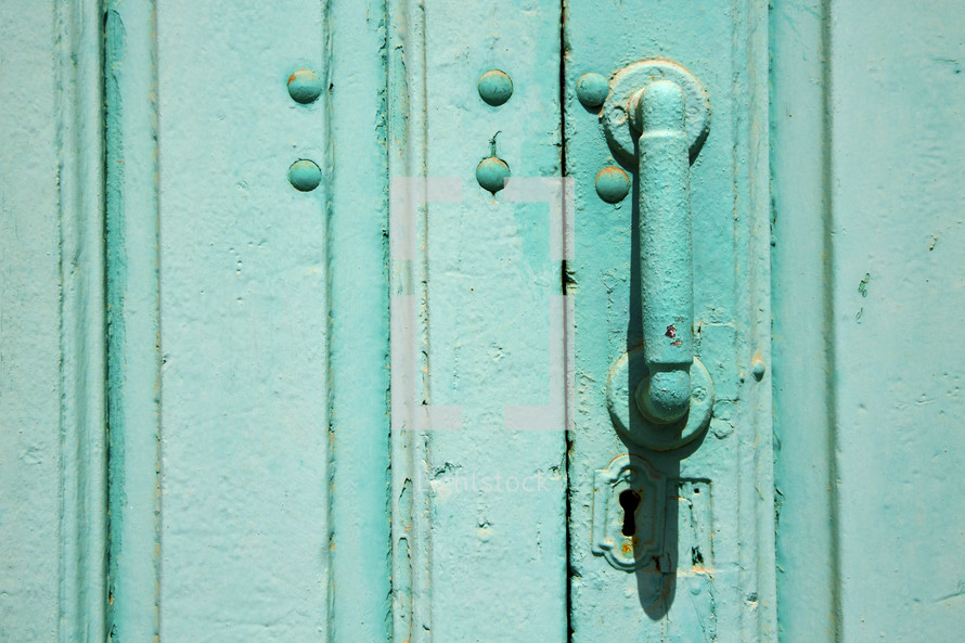 door handle on a turquoise door 