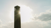 Cloud and sun movement behind the clock tower on the campus of Texas A&M University.
