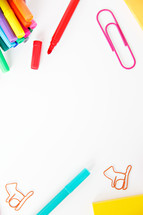 markers, and paperclips on a white background 