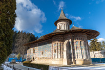 Landscape shot of the old painted medieval Voronet Monastery, famous for the blue shade of vornet.