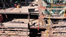 Building construction site pullback aerial view