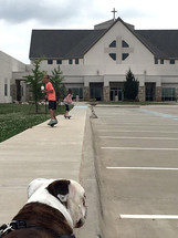 kids skateboarding in a church parking lot 