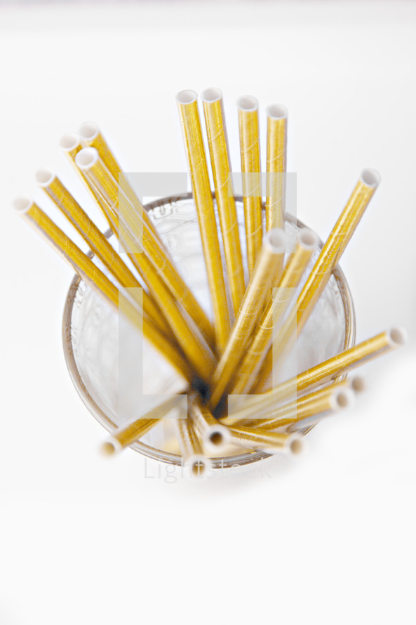 gold cocktail straws in a glass 