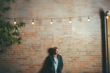 woman standing under a strand of lights