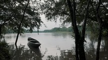 Lonely Wooden Boat Floating On Calm Lake In Amazon Rainforest Of Ecuador. Static Shot	