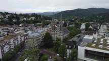 Aerial view circling Stadtkirche evangelical church in Baden-Baden town centre, Germany