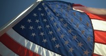 Closeup of stars and stripes on USA, American flag flying for 4th of July.