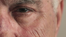 face and blinking eye of a senior man 