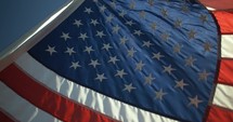 American, USA flag blowing in the wind in slow motion on 4th of July, Independence Day.