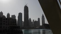 Distant skyscraper, buildings in Dubai under construction with cranes on the to near the Burj Khalifa at Dubai mall.