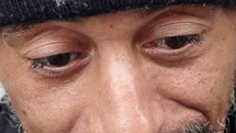 Close up of a gray bearded man's eyes.