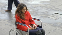 young woman in a wheelchair texting 