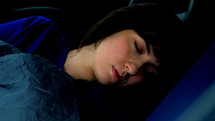 a woman sleeping in a car 