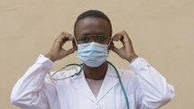 a healthcare working putting on a mask 