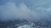 Communication mast on the snowy hill