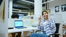 Young Businesswoman Talking on Phone at Office Cubicle
