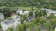 Aerial: St. Johannis-Kirche, Baden-Baden, amidst greenery and urban backdrop