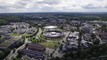 Aerial view orbiting colourful Baden Baden Gewerbepark modern shopping Cité futuristic skyline