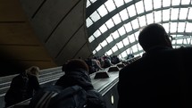 People on Canary Wharf tube station escalators in London