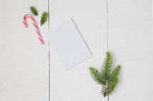 candy canes and pine boughs with blank white paper 
