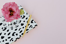 dalmatian spotted notebook, pen, and flowers in a vase 